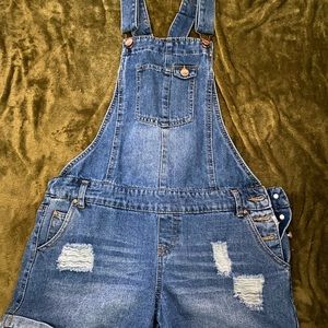 slightly ripped denim overalls